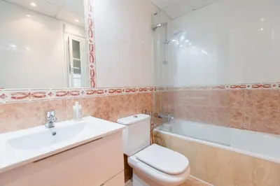 a bathroom with a toilet and a sink and a bath tub at Apartamento El Patio de Canovas in Cádiz