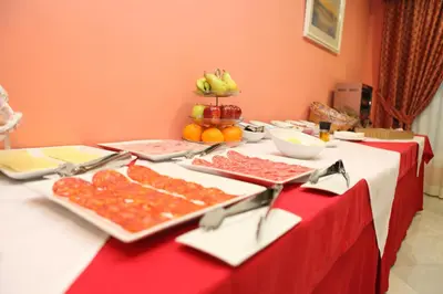 a table with a red table cloth with food on it at Chaikana in El Puerto de Santa María