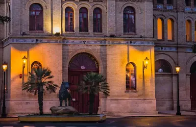 a building with a statue in front of it at Pensión La Palma in El Puerto de Santa María