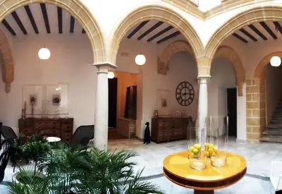 a large room with a table with fruit on it at Palacio Torneria in Jerez de la Frontera