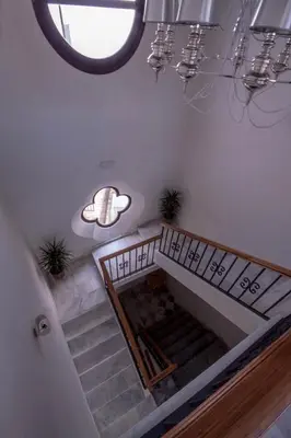 a room with stairs and a round window at Palacio Torneria in Jerez de la Frontera