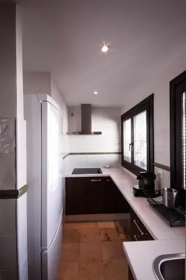 a kitchen with a refrigerator and a sink at Palacio Torneria in Jerez de la Frontera