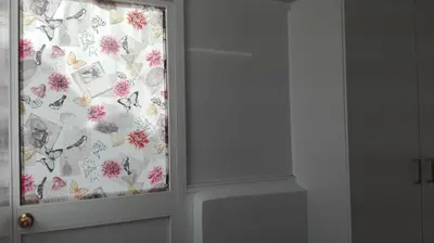 a window with a curtain with butterflies on it at Casa Blanca in Rota