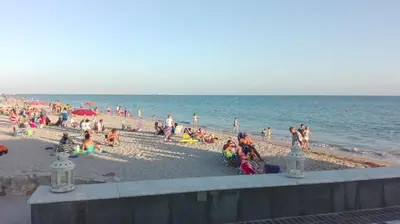 a group of people on a beach near the water at Casa Blanca in Rota