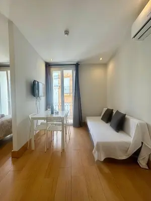 a bedroom with a bed and a table and a desk at Alcazar Suites in Jerez de la Frontera