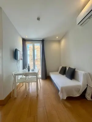 a bedroom with a bed and a table and a desk at Alcazar Suites in Jerez de la Frontera