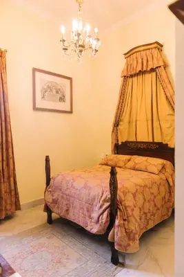 a bedroom with a bed with a canopy at Palacio del Virrey Laserna in Jerez de la Frontera