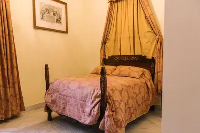 a bedroom with a bed with a canopy at Palacio del Virrey Laserna in Jerez de la Frontera