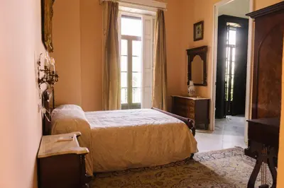 a bedroom with a bed and a window at Palacio del Virrey Laserna in Jerez de la Frontera