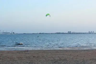 a person flying a kite over a body of water at Apartamento Tres Carretas Puerto Real in Puerto Real