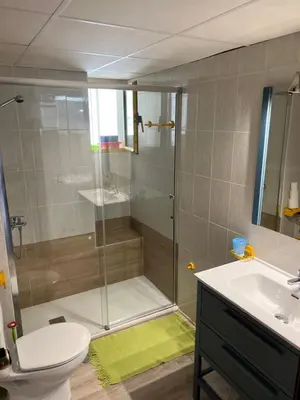 a bathroom with a shower and a toilet and a sink at Piso frente la playa de Valdelagrana in El Puerto de Santa María