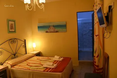 a kitchen with a sink and green cabinets at Hostal Costa de la Luz in Chipiona