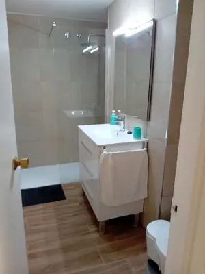 a bathroom with a white sink and a shower at Valdelagrana Mar Ha Apartment in El Puerto de Santa María