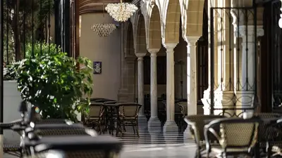 a row of chairs and tables in a building at Hotel Casa Palacio María Luisa in Jerez de la Frontera