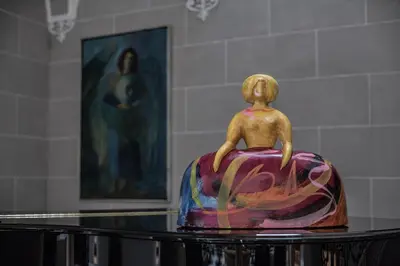 a statue of a woman sitting on top of a table at Hotel Casa Palacio María Luisa in Jerez de la Frontera