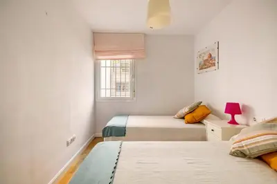 a bedroom with two beds and a window at Modern design apartament in Conil! in Conil de la Frontera