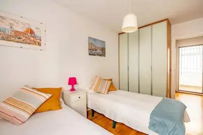 a bedroom with two beds and a window at Modern design apartament in Conil! in Conil de la Frontera