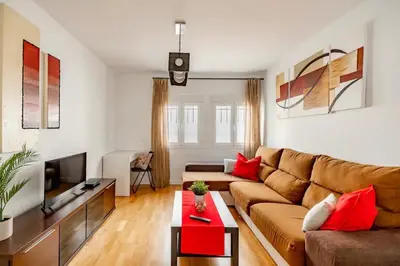 a living room with a couch and a tv at Modern design apartament in Conil! in Conil de la Frontera