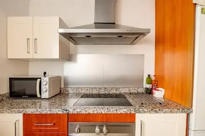 a kitchen with a sink and a microwave at Modern design apartament in Conil! in Conil de la Frontera