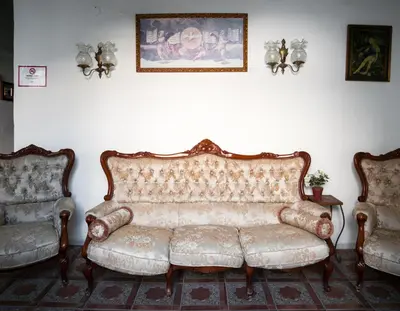 a living room with a couch and two chairs at Apartamentos Jerez in Jerez de la Frontera