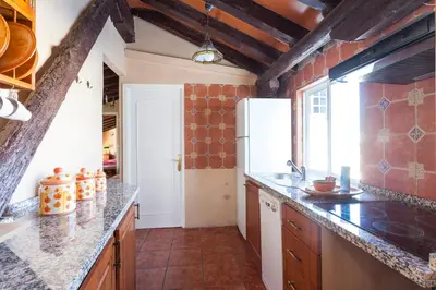 a kitchen with a refrigerator and a counter top at Apartamentos Jerez in Jerez de la Frontera