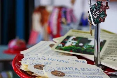 a table with a bunch of books and a key at Casa de Huéspedes Santa Maria in El Puerto de Santa María