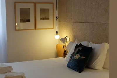 a bedroom with a bed with a pillow on it at Casa de Huéspedes Santa Maria in El Puerto de Santa María