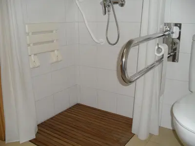 a bathroom with a shower with a shower curtain and a toilet at Hostal San Marcos in San Fernando