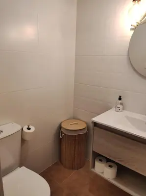 a small bathroom with a toilet and a sink at Natipao in Rota