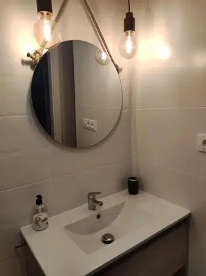 a bathroom with a sink and a mirror at Natipao in Rota