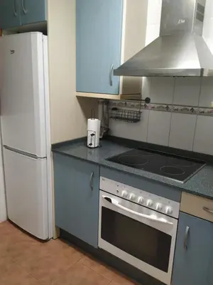 a kitchen with a stove and a refrigerator at Natipao in Rota