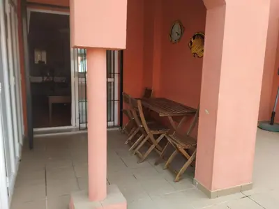 a room with chairs and a table and a clock at Natipao in Rota