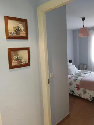 a bedroom with a bed and two pictures on the wall at Natipao in Rota