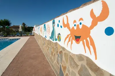 a wall with a painting of a crab on it at Apartamentos El Palmeral in Conil de la Frontera