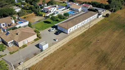 an aerial view of a town with houses and a field at Apartamentos El Palmeral in Conil de la Frontera