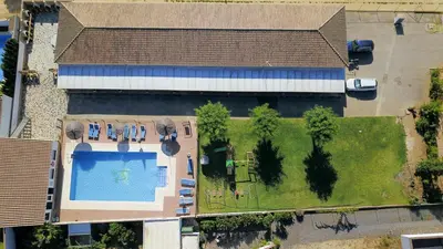 an overhead view of a house with a yard with a swimming pool at Apartamentos El Palmeral in Conil de la Frontera