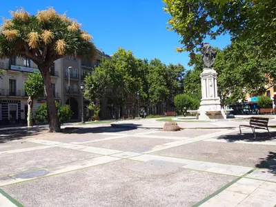 a park with a statue and a bench and trees at Casa Valientes B - Parking privado gratis & patio interior in Jerez de la Frontera