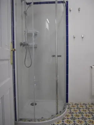 a shower with a glass door in a bathroom at Casa Valientes B - Parking privado gratis & patio interior in Jerez de la Frontera