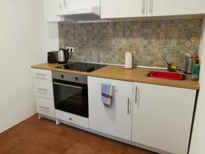 a kitchen with a sink and a stove top oven at Casa Valientes B - Parking privado gratis & patio interior in Jerez de la Frontera