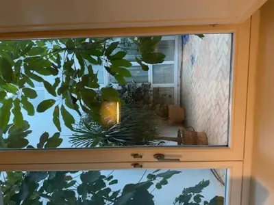 a window with a view of a room with a mirror at Casa Palacio de Cadiz in Cádiz