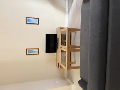 a living room with a tv and a shelf at Casa Palacio de Cadiz in Cádiz