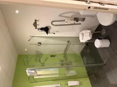 a bathroom with a glass counter with a person on a shelf at Casa Palacio de Cadiz in Cádiz