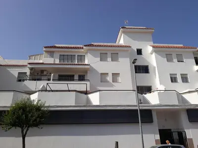 a white building with a tree in front of it at El Marinero in Rota