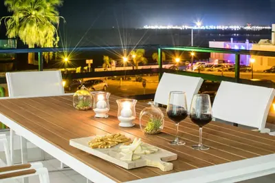 a table with glasses of wine and a plate of food at Panther Home Manantial in El Puerto de Santa María