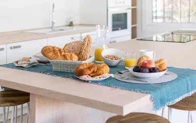 a breakfast table with bread and fruit on it at Panther Home Manantial in El Puerto de Santa María