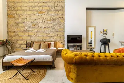a bedroom with a large bed and a couch at Entre Bodegas Jerez in Jerez de la Frontera