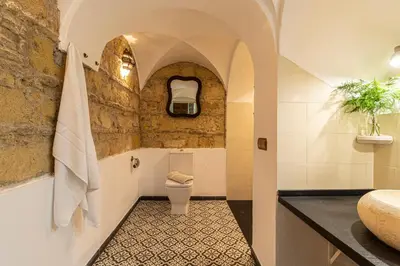 a bathroom with a toilet and a sink at Entre Bodegas Jerez in Jerez de la Frontera