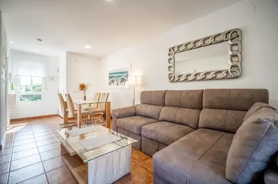 a living room with a couch and a table at Precioso Apartamento Jardin del Golf 1, Novo Sancti Petri in Chiclana de la Frontera