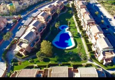 an aerial view of a building with a blue funnel at Precioso Apartamento Jardin del Golf 1, Novo Sancti Petri in Chiclana de la Frontera