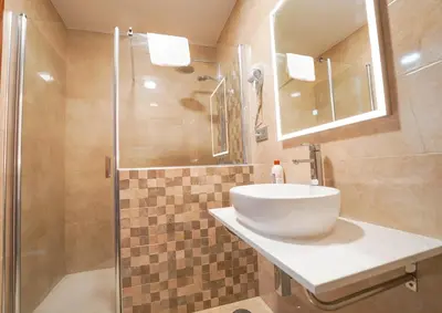a bathroom with a sink and a shower at Hostal Los Mellizos in Conil de la Frontera